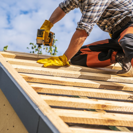 DIYA contractor using a power drill installing framing for a roof.